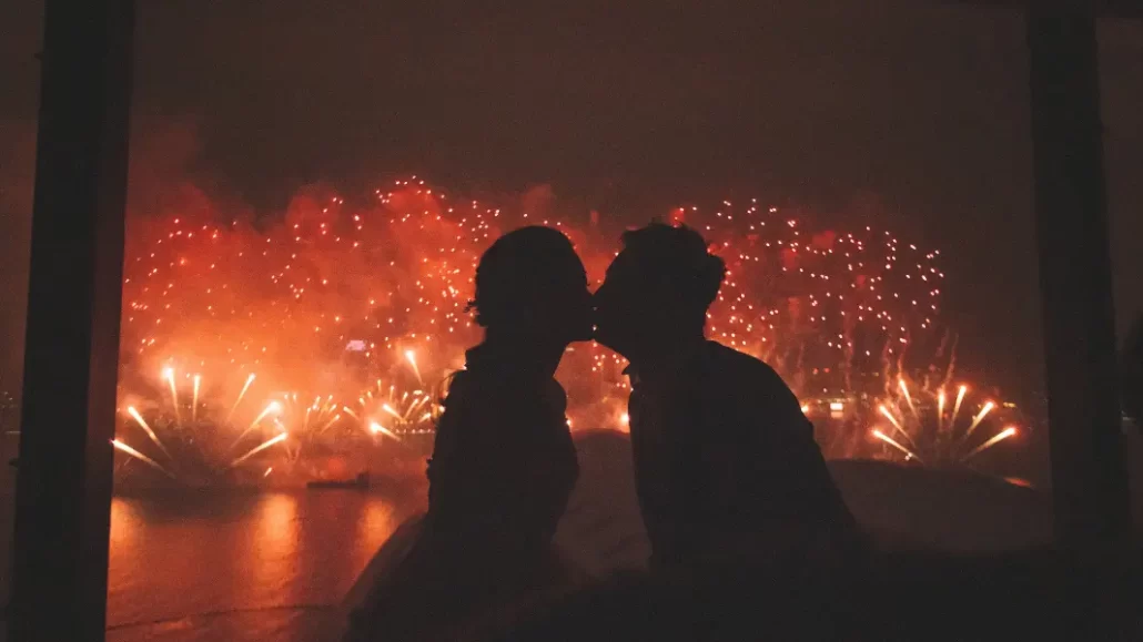 couple kissing under fireworks