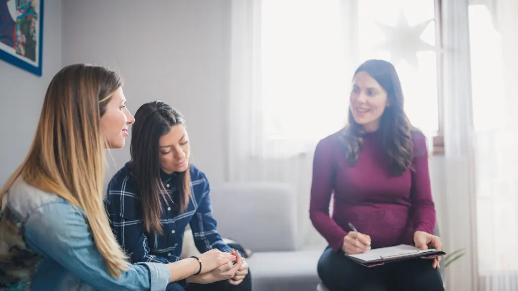 Lesbian couple receiving couples counseling to work on their relationship.