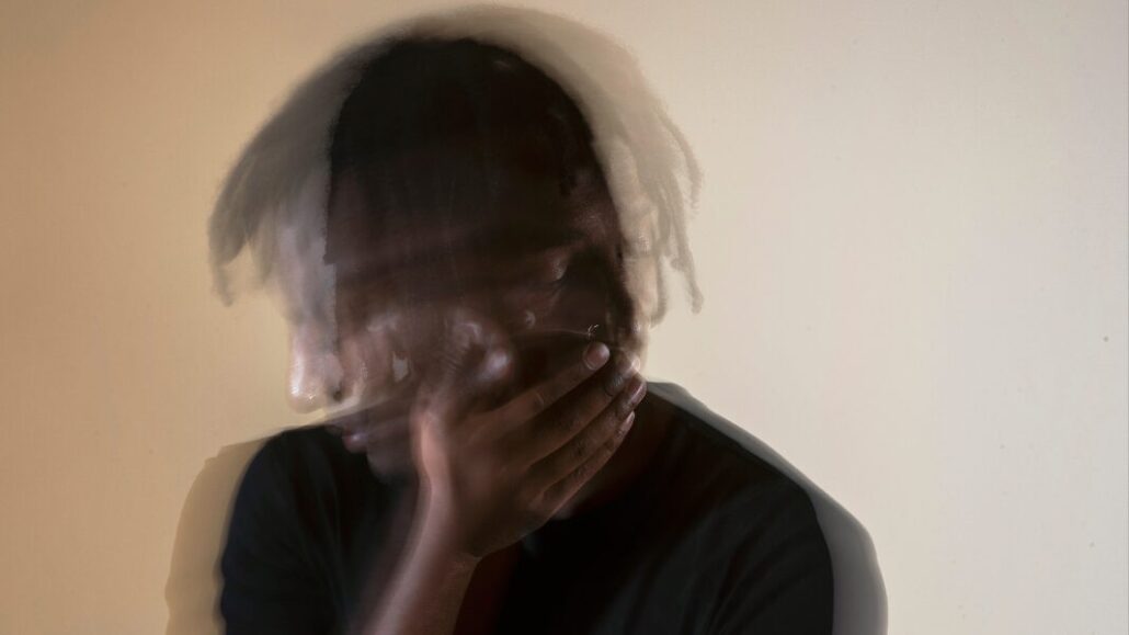 anxious man holding side of head