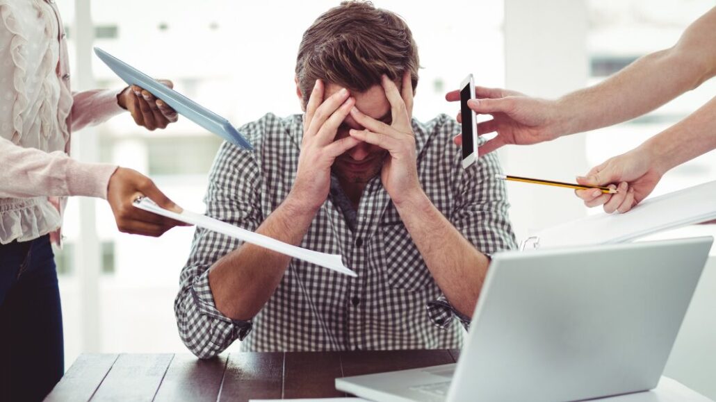 overwhelmed man at work with high functioning depression