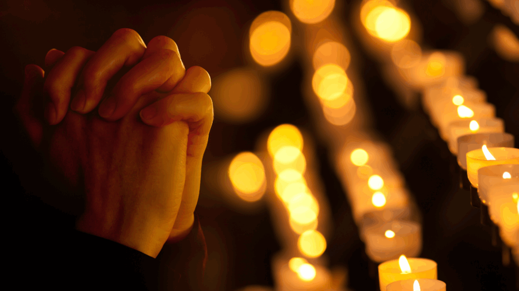 praying hands with religious trauma