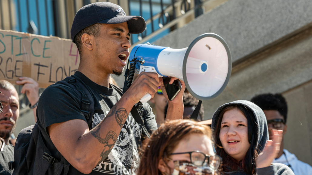 man at a political protest engaging in activism and mental health